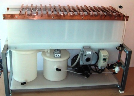 Electrowinning pilot plant with an electrowinning cell, anodes. cathodes, electrolyte vessels, immersion heater, and circulation pump.